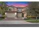 Charming two-story home features a three-car garage, beautiful landscaping, and a welcoming entrance at 1938 Filly Trl, Oviedo, FL 32765
