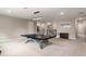 Bright game room with ping pong table, neutral carpet, modern lighting and staircase view at 1938 Filly Trl, Oviedo, FL 32765