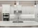 Close-up of a kitchen featuring white cabinets, stainless steel appliances, and a large island at 1938 Filly Trl, Oviedo, FL 32765