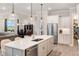 Open-concept kitchen with stainless steel appliances, a large island, and seamless flow to the living area at 1938 Filly Trl, Oviedo, FL 32765