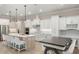 Bright kitchen with white cabinets, stainless steel appliances, an island, and a breakfast table at 1938 Filly Trl, Oviedo, FL 32765