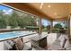 Enjoy outdoor living on this cozy covered patio with a pool view at 1938 Filly Trl, Oviedo, FL 32765