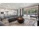Open-concept living and kitchen area with a large sectional and view of the pool at 1938 Filly Trl, Oviedo, FL 32765
