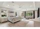 Generously sized main bedroom includes a seating area, tray ceiling, and recessed lighting at 1938 Filly Trl, Oviedo, FL 32765