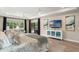 Tranquil main bedroom features tray ceilings, seating area, and a view of the pool at 1938 Filly Trl, Oviedo, FL 32765