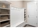 Mudroom featuring coat hooks, storage benches, shelves and direct access to the exterior at 1938 Filly Trl, Oviedo, FL 32765