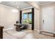 Bright home office with a large window, white door, and wood-look tile floor at 1938 Filly Trl, Oviedo, FL 32765