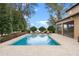 Beautiful backyard pool and travertine deck, with an expansive screened lanai and relaxing lounge chairs at 1938 Filly Trl, Oviedo, FL 32765