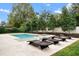 Backyard oasis with a sparkling pool, jacuzzi, and stylish lounge chairs for relaxation at 1938 Filly Trl, Oviedo, FL 32765
