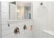 Modern walk-in shower with white subway tile, bronze fixtures, and a built-in corner seat at 1938 Filly Trl, Oviedo, FL 32765