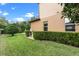 Well-maintained backyard with lush lawn, trimmed hedges, and the exterior of the home at 1938 Filly Trl, Oviedo, FL 32765