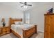 Cozy bedroom featuring a bed, nightstand, dresser and window with plantation shutters at 1947 Plantation Oak Dr, Orlando, FL 32824