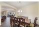 A dining room showcasing an elegant chandelier and dark wood floors at 1947 Plantation Oak Dr, Orlando, FL 32824