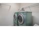 Efficient laundry area featuring side-by-side washer and dryer for convenient chore management at 1947 Plantation Oak Dr, Orlando, FL 32824