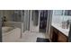 Well-lit bathroom featuring a walk-in shower, bathtub, walk-in closet, and tile floors at 2133 Korat Ln, Maitland, FL 32751
