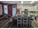 Spacious kitchen with stainless steel appliances, an island with seating, and an adjacent dining area at 2133 Korat Ln, Maitland, FL 32751