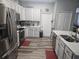 Bright kitchen featuring white cabinetry, stainless steel appliances, and plenty of counter space at 2133 Korat Ln, Maitland, FL 32751