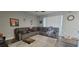 Spacious living room featuring a large sectional sofa, a ceiling fan, and lots of natural light at 2133 Korat Ln, Maitland, FL 32751