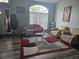 Inviting living room featuring a plush sofa, cozy chairs, and a stylish rug on the floor at 2133 Korat Ln, Maitland, FL 32751