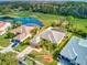 Aerial view of a home with a screened-in lanai, paver driveway, and golf course views at 2439 Teton Stone Run, Orlando, FL 32828