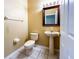 Powder room featuring a pedestal sink, toilet, and tile flooring, offering a practical and stylish space at 2439 Teton Stone Run, Orlando, FL 32828