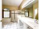 Bright bathroom with a glass enclosed shower, soaking tub, and dual sink vanity at 2439 Teton Stone Run, Orlando, FL 32828