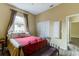 Bedroom featuring a wrought iron bed frame, wood-look floors, closet, and neutral walls, creating a relaxing space at 2439 Teton Stone Run, Orlando, FL 32828
