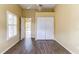 Bedroom with wood-look floors, closet, and neutral walls, creating a comfortable and functional living space at 2439 Teton Stone Run, Orlando, FL 32828
