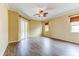 Spacious bedroom with wood-look floors, ceiling fan, and sliding glass doors leading to the outdoors at 2439 Teton Stone Run, Orlando, FL 32828