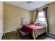 Bedroom featuring a wrought iron bed frame, wood-look floors, and neutral walls, creating a cozy retreat at 2439 Teton Stone Run, Orlando, FL 32828