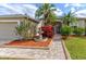 Charming front entrance with brick walkway, lush landscaping, and elegant double doors at 2439 Teton Stone Run, Orlando, FL 32828