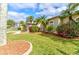 Beautiful front yard with manicured lawn, decorative landscaping, and flowering shrubs enhancing curb appeal at 2439 Teton Stone Run, Orlando, FL 32828