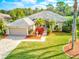Beautifully landscaped home featuring a meticulously maintained lawn, colorful flowerbeds, and decorative fountain at 2439 Teton Stone Run, Orlando, FL 32828