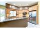 Well-lit kitchen with stainless steel appliances, granite counters and tile backsplash at 2439 Teton Stone Run, Orlando, FL 32828
