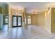 Spacious living room featuring tile floors, large windows, and elegant light fixtures at 2439 Teton Stone Run, Orlando, FL 32828