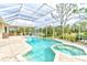 Screened in pool and spa offers a beautiful backyard escape with an outdoor kitchen and golf course views at 2439 Teton Stone Run, Orlando, FL 32828