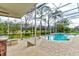 Screened in pool and spa offers a beautiful backyard escape with an outdoor kitchen and golf course views at 2439 Teton Stone Run, Orlando, FL 32828