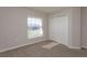 Bedroom features neutral paint and carpet with a window and closet at 2447 Matterhorn Trl, Davenport, FL 33837