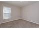 Cozy bedroom with neutral paint and carpet, plus a sunny window at 2447 Matterhorn Trl, Davenport, FL 33837