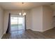 Bright dining area features sliding glass doors to the backyard and modern light fixture at 2447 Matterhorn Trl, Davenport, FL 33837