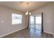 Bright dining area features sliding glass doors to the backyard and modern light fixture at 2447 Matterhorn Trl, Davenport, FL 33837