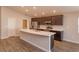 Modern kitchen featuring a large island, stainless steel appliances, and ample cabinet space at 2447 Matterhorn Trl, Davenport, FL 33837