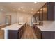 Modern kitchen featuring a long island with a sink and stainless steel appliances at 2447 Matterhorn Trl, Davenport, FL 33837