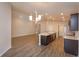 Open-concept living room and kitchen with center island, stainless appliances, and recessed lighting at 2447 Matterhorn Trl, Davenport, FL 33837