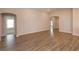 Spacious living room featuring wood-look floors and architectural archways at 2447 Matterhorn Trl, Davenport, FL 33837
