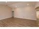 Bright living room with recessed lighting and neutral walls, complemented by stylish wood-look flooring at 2447 Matterhorn Trl, Davenport, FL 33837