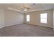 Spacious main bedroom features tray ceiling, plush carpet, and plenty of natural light at 2447 Matterhorn Trl, Davenport, FL 33837