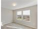Bedroom with two sunny windows overlooking the backyard and a neutral color palette at 2682 Mead Ave, St Cloud, FL 34771