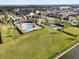 Aerial view of a pool and recreational area with a playground, basketball court, and ample green space at 2682 Mead Ave, St Cloud, FL 34771