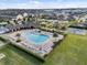 Aerial view of the community pool, playground, and clubhouse surrounded by lush landscaping at 2682 Mead Ave, St Cloud, FL 34771